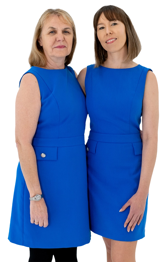 Two women wearing matching royal blue sleeveless dresses
